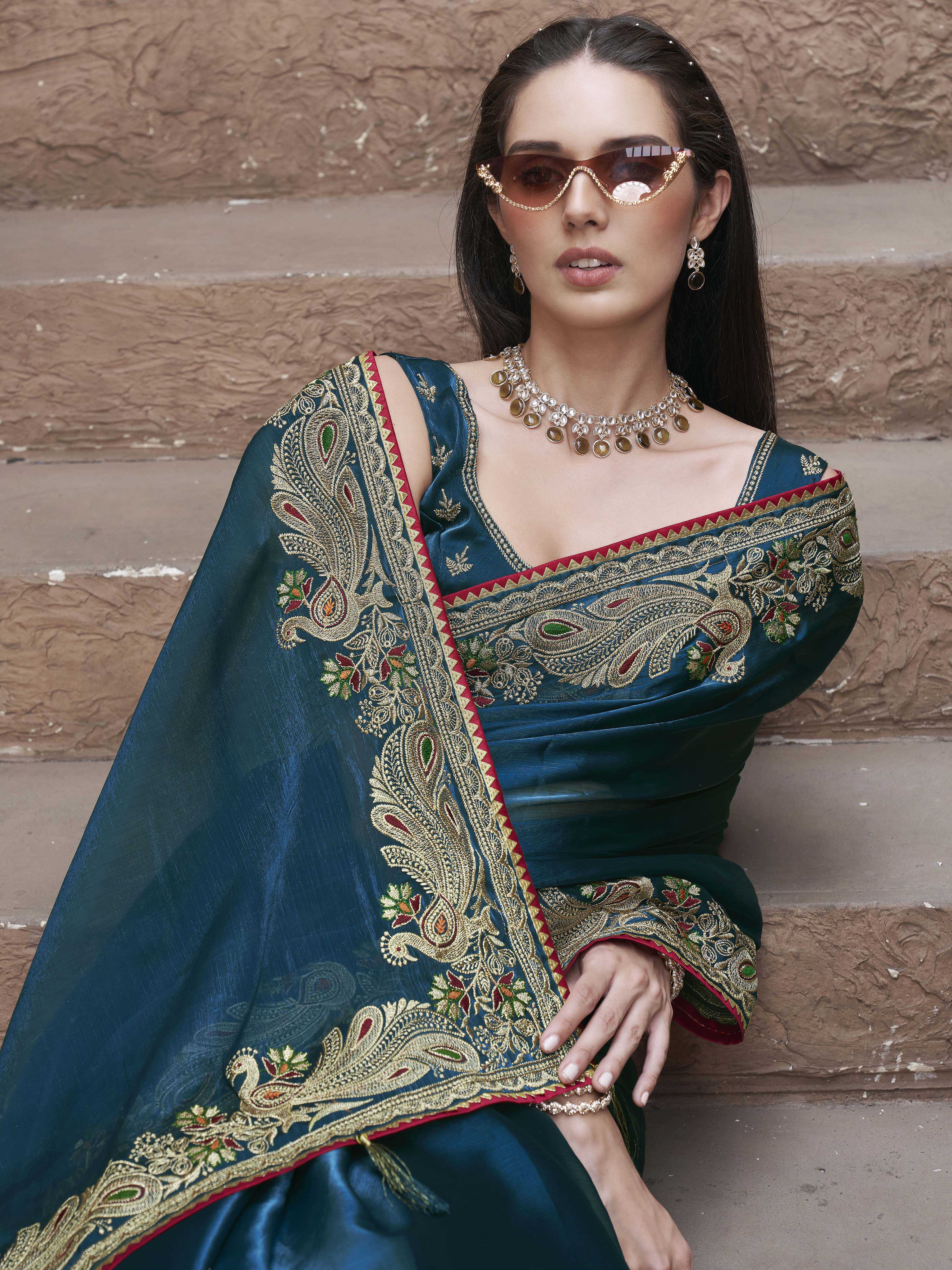Teal colored zari embroidered saree